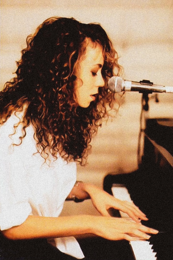 Mariah Carey playing the piano and singing in 1990